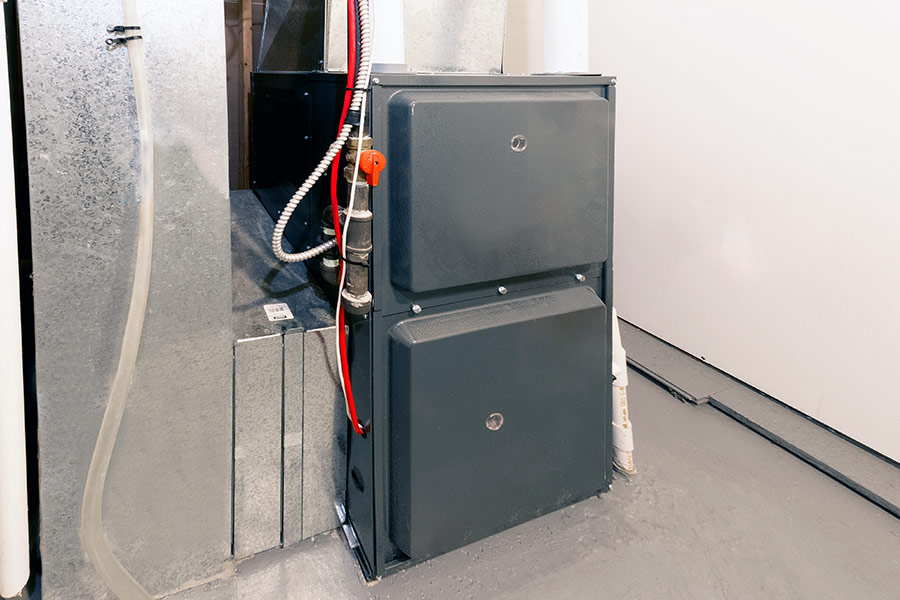 Modern HVAC furnace unit installed in a clean basement
